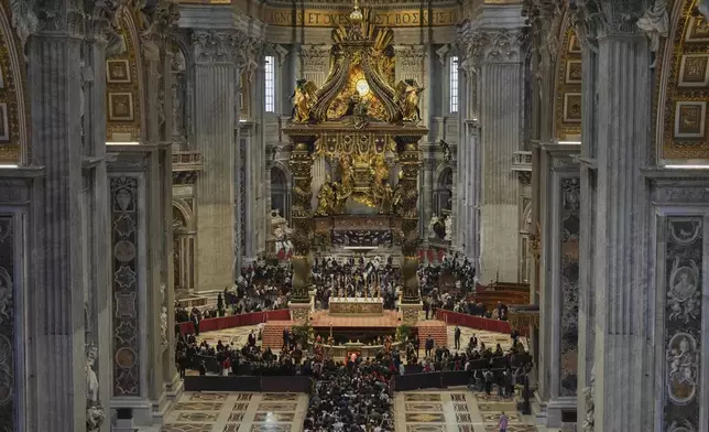People line up to pay their respects to Pope Francis lying in state, inside St. Peter's Basilica, at the Vatican, Friday, April 25, 2025. (AP Photo/Andrew Medichini)