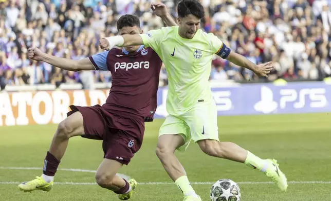 Trabzonspor's Taha Emre Ince, left, fights for the ball with Barcelona's Hugo Alba, right during the UEFA Youth League Final match between Trabzonspor and Barcelona, at the Colovray Sports Centre in Nyon, Switzerland, Monday, April 28, 2025. (Salvatore Di Nolfi/Keystone via AP)