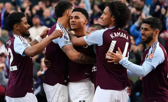 Aston Villa's Ollie Watkins, center, celebrates scoring with teammates during the English Premier League soccer match between Aston Villa and Newcastle United at Villa Park, Birmingham, England, Saturday April 19, 2025. (David Davies/PA via AP)