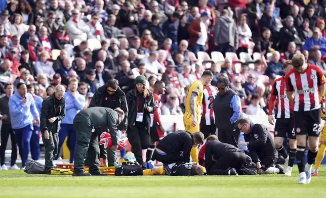 Brighton and Hove Albion's Jan Paul van Hecke receives treatment, during the English Premier League soccer match between Brentford and Brighton and Hove Albion, at the Gtech Community Stadium, London, Saturday April 19, 2025. (Adam Davy/PA via AP)