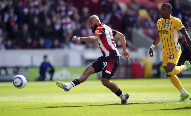Brentford's Bryan Mbeumo scores his side's first goal of the game, during the English Premier League soccer match between Brentford and Brighton and Hove Albion, at the Gtech Community Stadium, London, Saturday April 19, 2025. (Adam Davy/PA via AP)