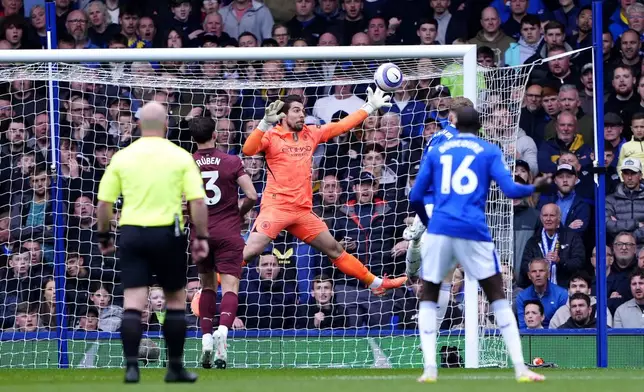 Manchester City goalkeeper Stefan Ortega saves a shot from Everton's Jarrad Branthwaite during the English Premier League soccer match between Everton and Manchester City at Goodison Park, Liverpool, England, Saturday April 19, 2025. (Peter Byrne/PA via AP)