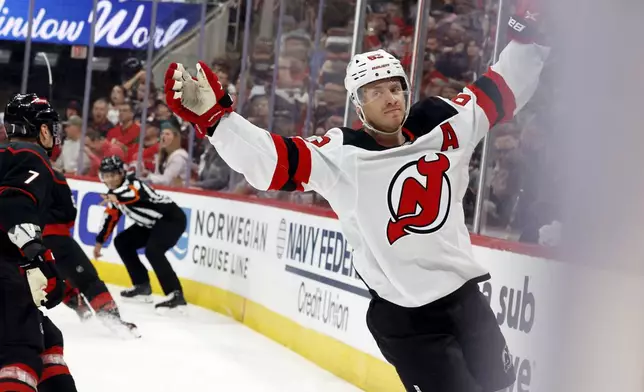 New Jersey Devils' Jesper Bratt (63) celebrates his goal against the Carolina Hurricanes during the first period of Game 2 of an NHL hockey Stanley Cup first-round playoff series in Raleigh, N.C., Tuesday, April 22, 2025. (AP Photo/Karl DeBlaker)