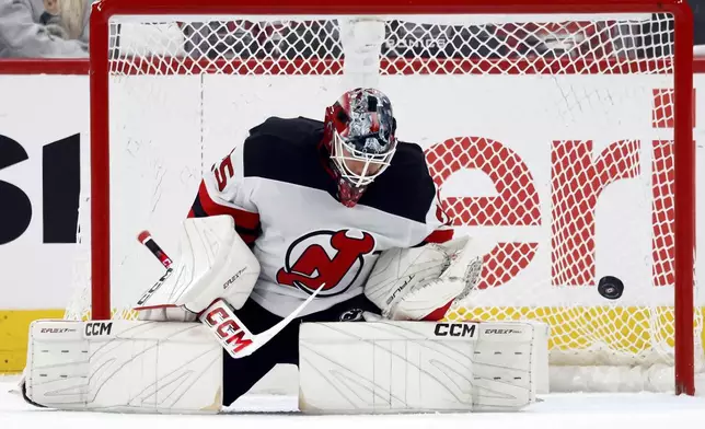New Jersey Devils goaltender Jacob Markstrom (25) blocks a shot of the Carolina Hurricanes during the third period of Game 2 of an NHL hockey Stanley Cup first-round playoff series in Raleigh, N.C., Tuesday, April 22, 2025. (AP Photo/Karl DeBlaker)