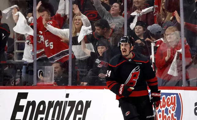 Carolina Hurricanes' Seth Jarvis (24) celebrates his empty net goal against the New Jersey Devils during the third period of Game 2 of an NHL hockey Stanley Cup first-round playoff series in Raleigh, N.C., Tuesday, April 22, 2025. (AP Photo/Karl DeBlaker)
