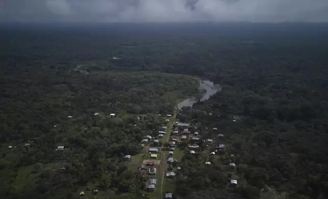 Villa Caleta, a community in Panama that used to benefit economically by being on the route migrants took after crossing the Darien Gap on their way north to the U.S., sits along the Tuquesa River, Monday, April 7, 2025. (AP Photo/Matias Delacroix)