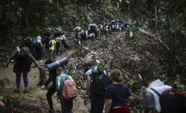 FILE - Migrants walk across the Darien Gap from Colombia to Panama in hopes of reaching the U.S., May 9, 2023. (AP Photo/Ivan Valencia, File)