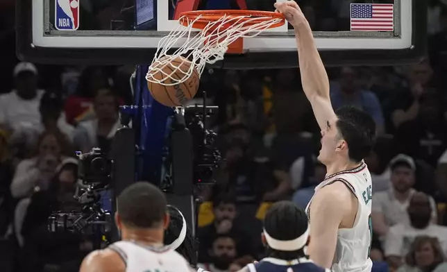Memphis Grizzlies center Zach Edey (14) dunks the ball during the second half of an NBA play-in tournament basketball game against the Dallas Mavericks, Friday, April 18, 2025, in Memphis, Tenn. (AP Photo/George Walker IV)