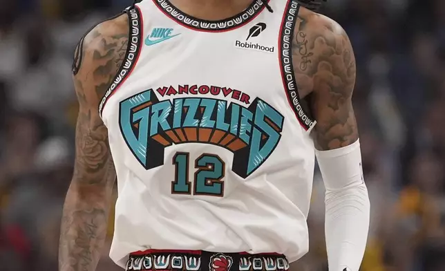 Memphis Grizzlies guard Ja Morant (12) celebrates during the first half of an NBA play-in tournament basketball game against the Dallas Mavericks, Friday, April 18, 2025, in Memphis, Tenn. (AP Photo/George Walker IV)