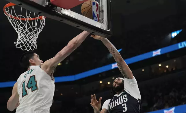 Memphis Grizzlies center Zach Edey (14) blocks a shot by Dallas Mavericks forward Anthony Davis (3) during the second half of an NBA play-in tournament basketball game Friday, April 18, 2025, in Memphis, Tenn. (AP Photo/George Walker IV)