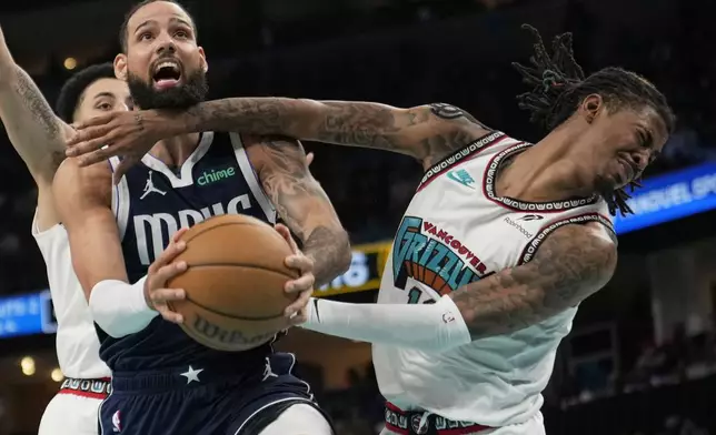 Dallas Mavericks forward Caleb Martin, left, and Memphis Grizzlies guard Ja Morant, right, collide during the second half of an NBA play-in tournament basketball game Friday, April 18, 2025, in Memphis, Tenn. (AP Photo/George Walker IV)