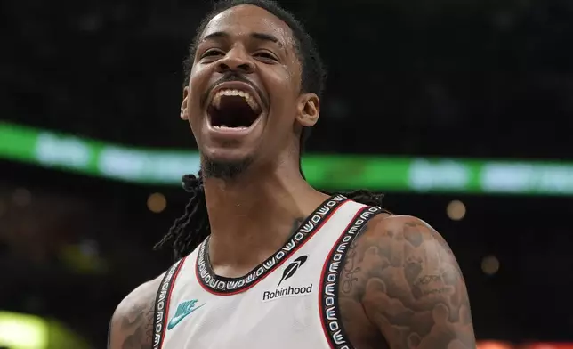 Memphis Grizzlies guard Ja Morant celebrates during the second half of an NBA play-in tournament basketball game against the Dallas Mavericks, Friday, April 18, 2025, in Memphis, Tenn. (AP Photo/George Walker IV)