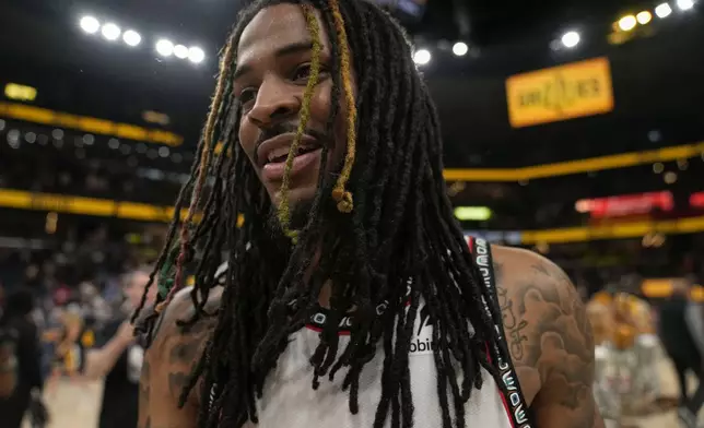 Memphis Grizzlies guard Ja Morant (12) celebrates the team's win after an NBA play-in tournament basketball game against the Dallas Mavericks, Friday, April 18, 2025, in Memphis, Tenn. (AP Photo/George Walker IV)