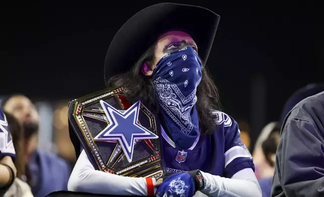 A Dallas Cowboys fan attends an NFL football draft party in Frisco, Texas, Thursday, April 24, 2025. (AP Photo/Gareth Patterson)