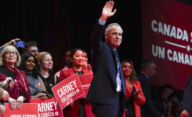 Canadian Prime Minister Mark Carney waves after his speech at his campaign headquarters after the Liberal Party won the Canadian election in Ottawa, Tuesday, April 29, 2025. (Justin Tang//The Canadian Press via AP)