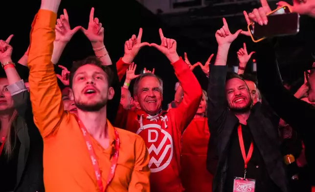 Canadian Prime Minister Mark Carney,center, dances to Canadian band Down With Webster as they play live at campaign headquarters after the Liberal Party won the Canadian election in Ottawa on Tuesday, April 29, 2025. (Sean Kilpatrick/The Canadian Press via AP)