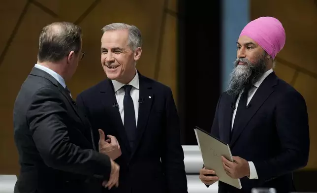 Bloc Quebecois Leader Yves-Francois Blanchet, left to right, Liberal Leader Mark Carney and New Democratic Party Leader Jagmeet Singh talks following the English-language federal leaders' debate in Montreal, Thursday, April 17, 2025. (Adrian Wyld/The Canadian Press via AP)
