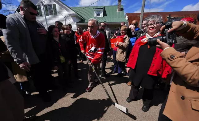 Canada Liberal Leader Mark Carney dawns a Hockey Canada jersey as he makes his way to play ball-hockey with youngsters during a campaign stop in Upper Onslow, Nova Scotia, Canada, Monday, April 21, 2025. (Sean Kilpatrick/The Canadian Press via AP)