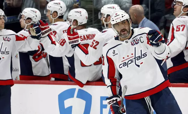 Washington Capitals' Alex Ovechkin (8) celebrates a goal against the Carolina Hurricanes during the second period of an NHL hockey game in Raleigh, N.C., Wednesday, April 2, 2025. (AP Photo/Karl DeBlaker)