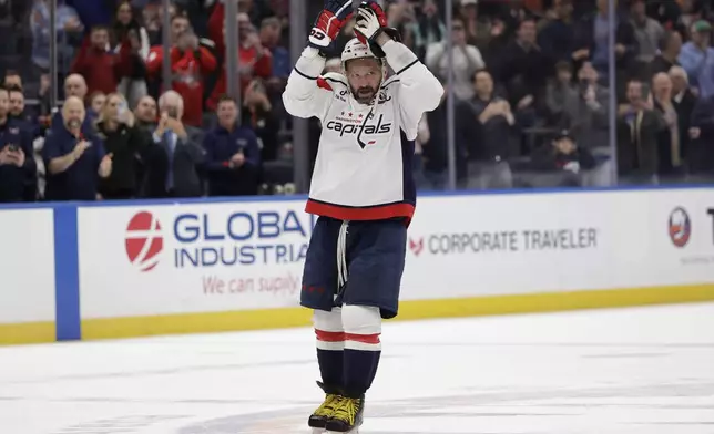 Washington Capitals left wing Alex Ovechkin (8) celebrates after scoring his 895th career goal during the second period of an NHL hockey game against New York Islanders in Elmont, N.Y., Sunday, April 6, 2025. (AP Photo/Adam Hunger)