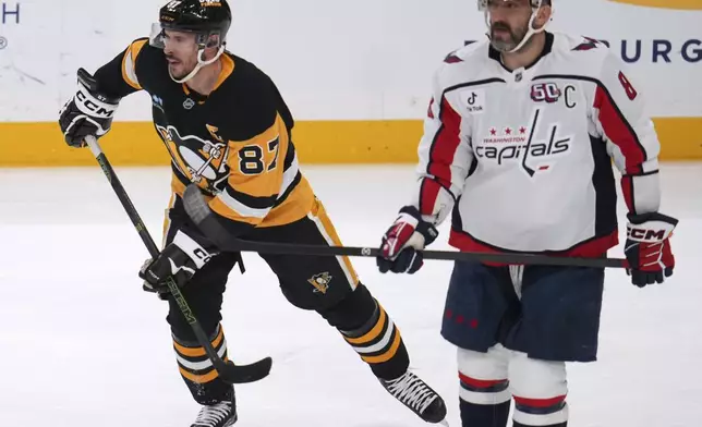 Pittsburgh Penguins' Sidney Crosby (87) and Washington Capitals' Alex Ovechkin (8) skate during the first period of an NHL hockey game in Pittsburgh, Thursday, April 17, 2025. (AP Photo/Gene J. Puskar)