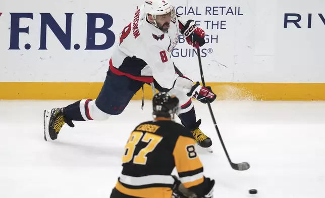 Washington Capitals' Alex Ovechkin (8) shoots with Pittsburgh Penguins' Sidney Crosby (87) defending during the first period of an NHL hockey game in Pittsburgh, Thursday, April 17, 2025. (AP Photo/Gene J. Puskar)