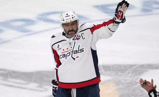 Washington Capitals' Alex Ovechkin acknowledges fans during a scoreboard tribute during the first period of an NHL hockey game against the Pittsburgh Penguins in Pittsburgh, Thursday, April 17, 2025. (AP Photo/Gene J. Puskar)