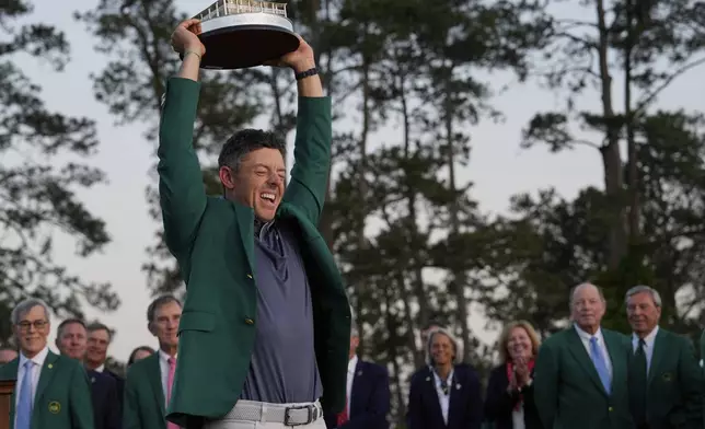 Winner Rory McIlroy, of Northern Ireland, holds the trophy at the Masters golf tournament, Sunday, April 13, 2025, in Augusta, Ga. (AP Photo/David J. Phillip)