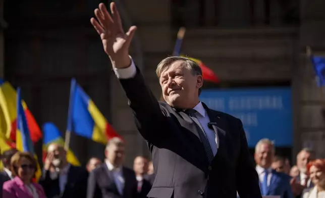 FILE - Crin Antonescu, presidential candidate for the ruling coalition, made of the Social Democratic Party (PSD), the Liberal Party (PNL) and the Democratic Alliance of Hungarians in Romania (UDMR), waves after registering his bid with the electoral authority in Bucharest, Romania, Sunday, March 9, 2025. (AP Photo/Vadim Ghirda, File)