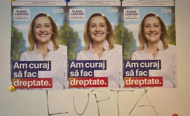 The word "Fight" is written on a board below posters of Elena Lasconi, presidential candidate for the Save Romania Union party, or USR, before it withdrew its support for her last week in favor of incumbent Bucharest mayor Nicusor Dan, at a party headquarter in Bucharest, Romania, Tuesday, April 15, 2025. (AP Photo/Vadim Ghirda)