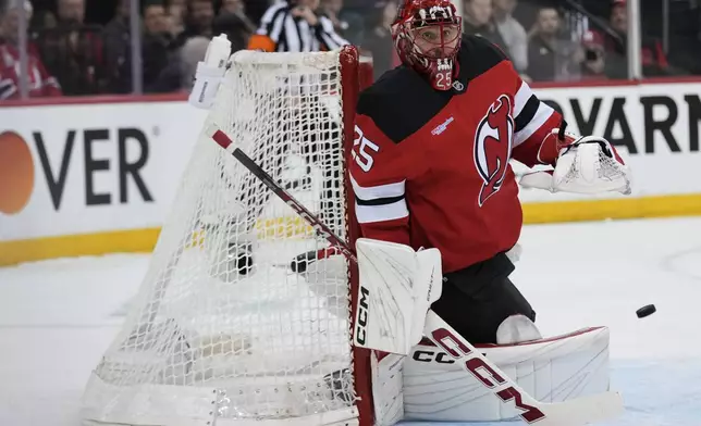 New Jersey Devils goaltender Jacob Markstrom defends the goal during the first period of Game 4 of an NHL hockey first-round series against the Carolina Hurricanes, Sunday, April 27, 2025, in Newark, N.J. (AP Photo/Seth Wenig)