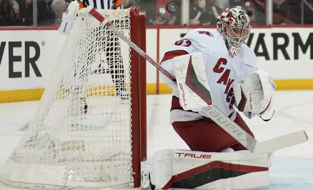 Carolina Hurricanes goaltender Pyotr Kochetkov makes a save during the second period of Game 4 of an NHL hockey first-round series against the New Jersey Devils, Sunday, April 27, 2025, in Newark, N.J. (AP Photo/Seth Wenig)