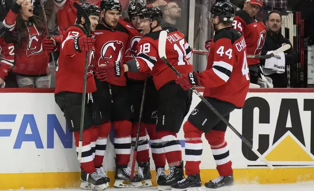New Jersey Devils' Timo Meier, second from left, celebrates his goal with teammates during the second period of Game 4 of an NHL hockey first-round series against the Carolina Hurricanes, Sunday, April 27, 2025, in Newark, N.J. (AP Photo/Seth Wenig)