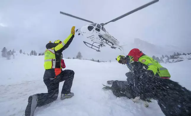 Italian National Alpine and Speleological Rescue Corps, attend a training in Col Gallina, near Cortina D'Ampezzo, northern Italy, Tuesday, March 25, 2025. (AP Photo/Luca Bruno)
