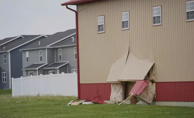Damage is visible at the scene after a car barreled through a building used for an after-school camp Tuesday, April 29, 2025, in Chatham, Ill. (AP Photo/Erin Hooley)