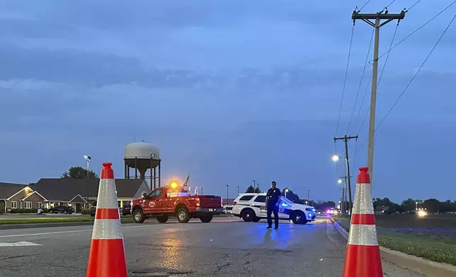 Police block a road leading to a building where a car smashed through during an after-school program, killing several people and injuring others, Monday, April 28, 2025, in Chatham, Ill. (AP Photo/John O'Connor)