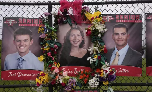 Flowers and ribbons decorate a picture of 18-year-old Rylee Britton, one of four people, including three young children, killed when a car barreled through a building used for an after-school camp, Tuesday, April 29, 2025, in Chatham, Ill. (AP Photo/Erin Hooley)