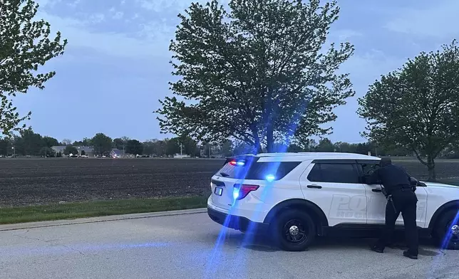 Police block a road leading to a building where a car smashed through during an after-school program, killing several people and injuring others, Monday, April 28, 2025, in Chatham, Ill. (AP Photo/John O'Connor)