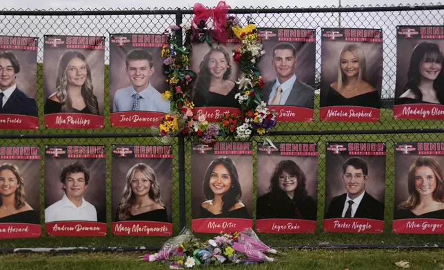 Flowers and ribbons decorate a picture of 18-year-old Rylee Britton, one of four people, including three young children, killed when a car barreled through a building used for an after-school camp, Tuesday, April 29, 2025, in Chatham, Ill. (AP Photo/Erin Hooley)