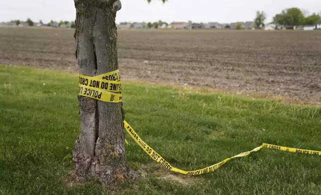 Police tape is left at the scene after a car barreled through a building used for an after-school camp Tuesday, April 29, 2025, in Chatham, Ill. (AP Photo/Erin Hooley)