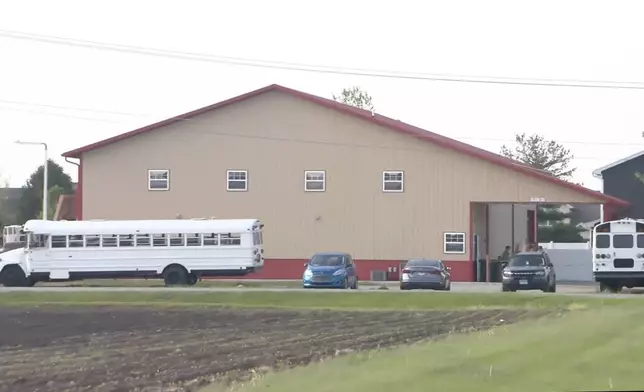 This image taken from video provided by WCIA shows first responders working the scene after a car smashed through a building during an after-school program, killing multiple people Monday, April 28, 2025, in Chatham, Ill. (WCIA via AP)