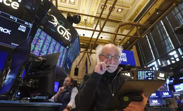 Trader Peter Tuchman, foreground, works on the floor of the New York Stock Exchange, Tuesday, April 29, 2025. (AP Photo/Richard Drew)