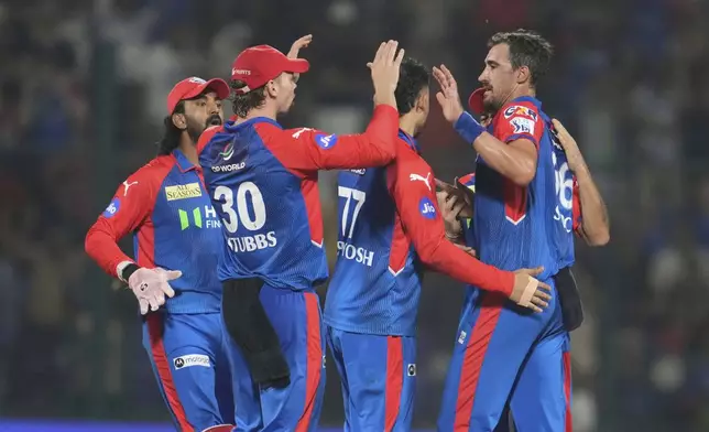 Delhi Capitals' Mitchell Starc, right, celebrates with teammates after the dismissal of Rajasthan Royals' Dhruv Jurel during the Indian Premier League cricket match between Delhi Capitals and Rajasthan Royals at Arun Jaitley Stadium in New Delhi, India, Wednesday, April 16, 2025. (AP Photo/Manish Swarup)