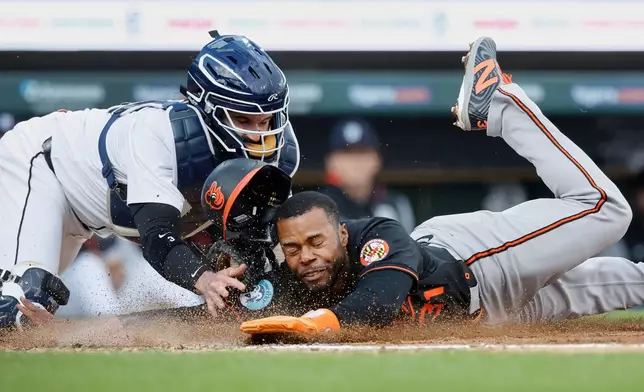 Baltimore Orioles' Cedric Mullins is tagged out by Detroit Tigers catcher Tomás Nido while trying to score from first base on a hit by Gunnar Henderson in the third inning during the second baseball game of a doubleheader Saturday, April 26, 2025, in Detroit. (AP Photo/Duane Burleson)