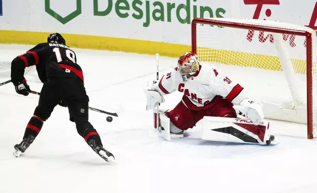 Ottawa Senators right wing Drake Batherson (19) scores against Carolina Hurricanes goaltender Frederik Andersen (31) during third-period NHL hockey game action in Ottawa, Ontario, Thursday, April 17, 2025. (Spencer Colby/The Canadian Press via AP)