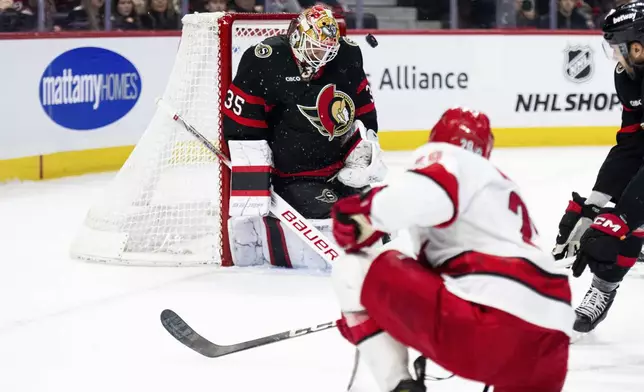 Ottawa Senators goaltender Linus Ullmark (35) blocks a shot by Carolina Hurricanes' Bradly Nadeau (29) during first-period NHL hockey game action in Ottawa, Ontario, Thursday, April 17, 2025. (Spencer Colby/The Canadian Press via AP)