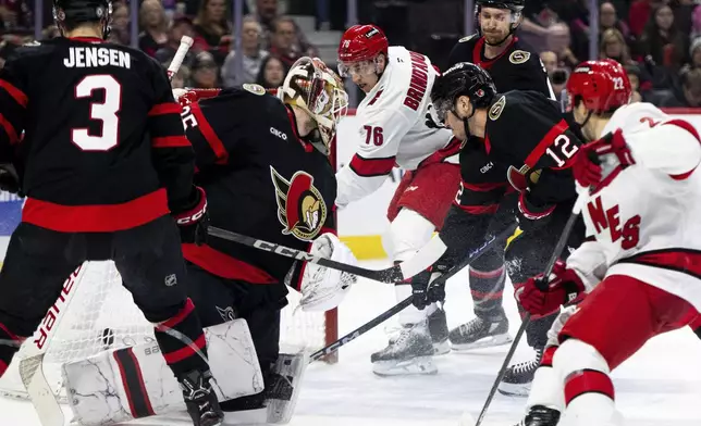 Carolina Hurricanes center Skyler Brind'Amour (76) scores against Ottawa Senators goaltender Linus Ullmark, second from left, during first-period NHL hockey game action in Ottawa, Ontario, Thursday, April 17, 2025. (Spencer Colby/The Canadian Press via AP)