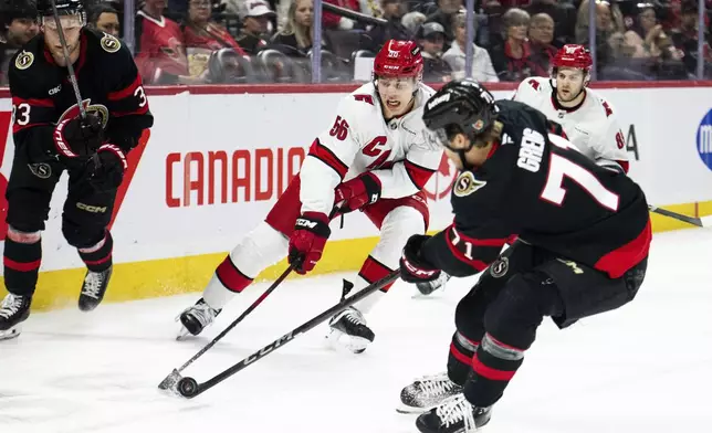 Carolina Hurricanes defenceman Scott Morrow (56) works under pressure from Ottawa Senators centre Ridly Greig (71) during second period NHL hockey action in Ottawa, on Thursday, April 17, 2025. (Spencer Colby/The Canadian Press via AP)