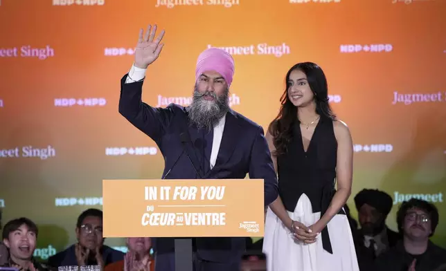 New Democratic Party Leader Jagmeet Singh addresses supporters accompanied by his wife Gurkiran Kaur at his campaign headquarters on election night, in Burnaby, B.C., Monday, April 28, 2025. (Ethan Cairns/The Canadian Press via AP)