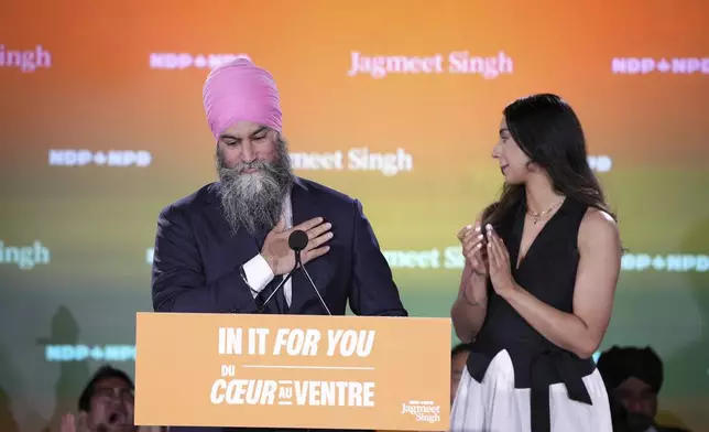 New Democratic Party Leader Jagmeet Singh addresses supporters accompanied by his wife Gurkiran Kaur at his campaign headquarters on election night, in Burnaby, B.C., Monday, April 28, 2025. (Ethan Cairns/The Canadian Press via AP)